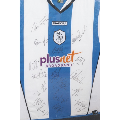 384 - A framed Diadora Sheffield Wednesday shirt from the 2007/2008 season, bearing seventeen players sign... 