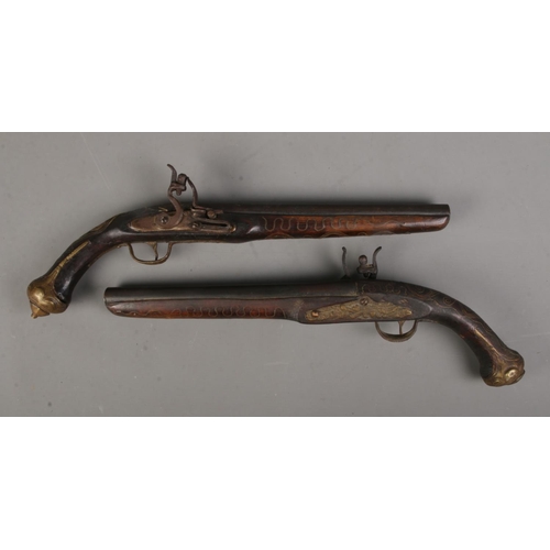 69 - A pair of reproduction flint lock duelling pistols. CANNOT POST OVERSEAS.