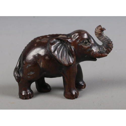 401 - A Japanese carved hardwood Netsuke formed as an Elephant and bearing three character mark to undersi... 