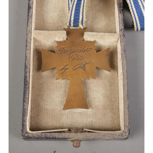 406 - A German Third Reich 'Cross of Honour of the German Mother' medal in fitted case. With enamelled blu... 