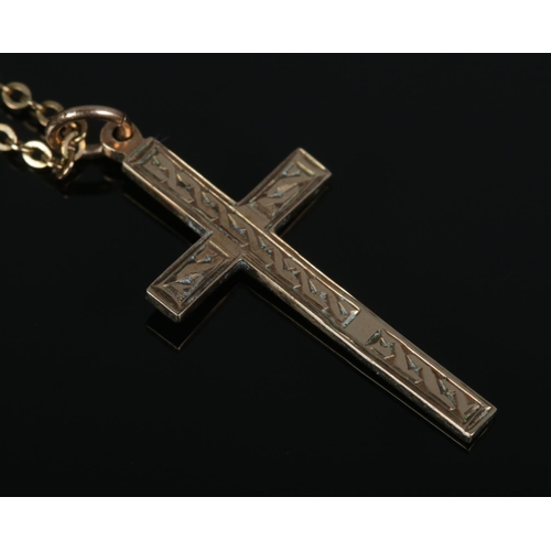 429 - A 9ct Gold crucifix pendant, on yellow metal chain. Weight of pendant: 1.1g.