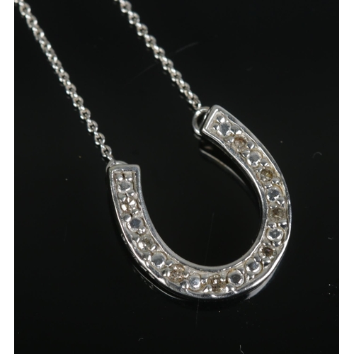 441 - A 9ct white gold and diamond set horseshoe necklace on chain. Total weight 2.8g.