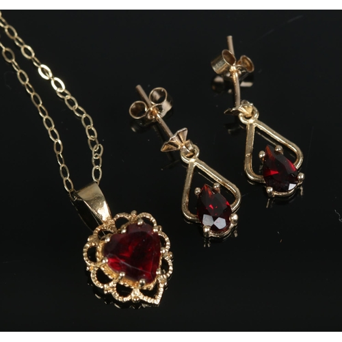 443 - A 9ct gold jewellery suite to include pendant on chain and earrings all set with garnets. Total weig... 