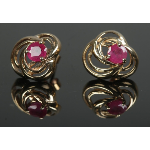 444 - A pair of 9ct gold stud earrings set with rubies. Total weight 1.6g.