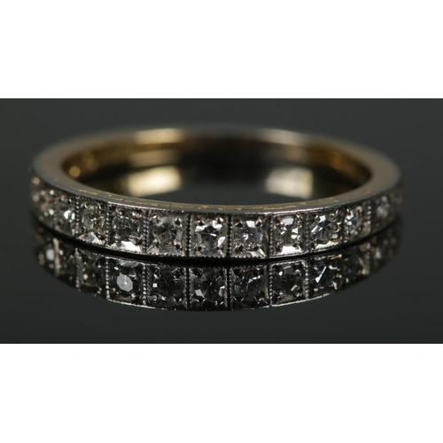 451 - An 18ct gold and platinum ring set with single cut graduated diamonds. Size Q½, 3.1g.