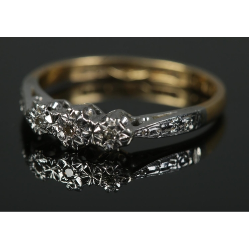 454 - An 18ct gold, platinum ring set with three diamonds. Size J, 1.9g.