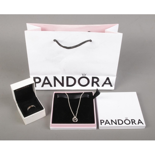 457 - A boxed silver Pandora pendant on chain along with a boxed silver Pandora ring. With original bag.