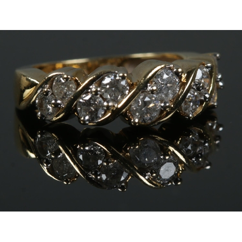 459 - An 18ct Gold and ten stone diamond ring, with the stones set in a rope twist setting. Size K. Total ... 