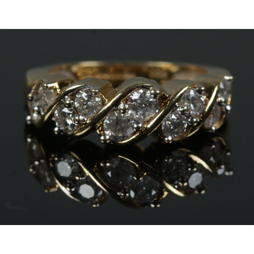 459 - An 18ct Gold and ten stone diamond ring, with the stones set in a rope twist setting. Size K. Total ... 