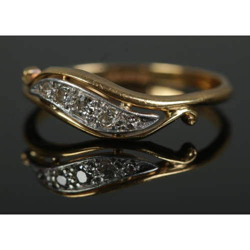 460 - An 18ct gold and scroll set five stone diamond ring. Size N½, 2.3g.