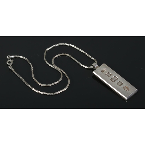 480 - A silver ingot on white metal chain. Ingot assayed for Birmingham, 1977 by James Harrison. Total wei... 