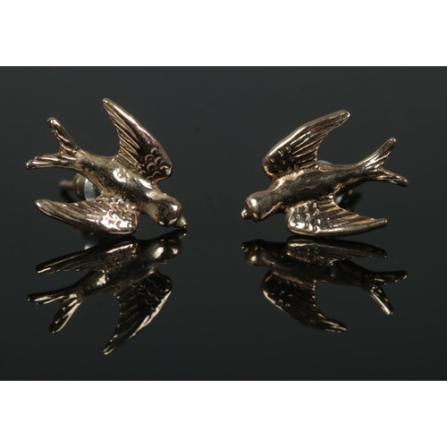 481 - A pair of 9ct earrings formed as swallows in flight. Total weight: 2.9g.