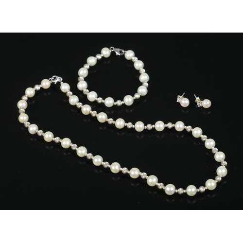 484 - A silver and pearl three piece jewellery suite. Consisting of necklace, bracelet and earrings. Neckl... 