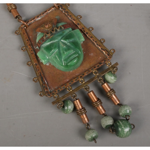 486 - A Mexican carved jade and gilt metal necklace and pendant.