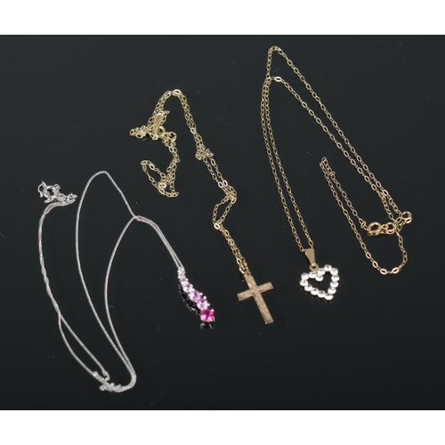 488 - Three 9ct gold necklaces to include crucifix and white gold and sapphire examples. Total weight 2.34... 