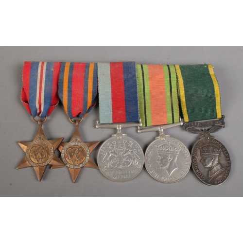 493 - A set of five medals on badge backing, to include 1939-1945 Star, The Burma Star, 1939-1945 Defence ... 