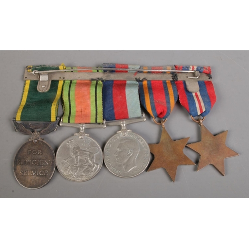 493 - A set of five medals on badge backing, to include 1939-1945 Star, The Burma Star, 1939-1945 Defence ... 