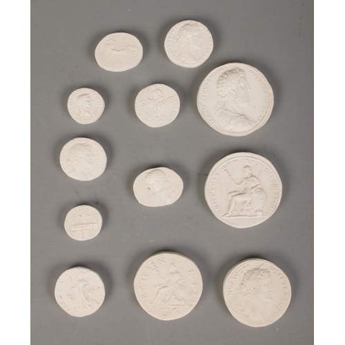 496 - A collection of museum plaster casts of mostly Roman coins. Includes early Britannia examples.