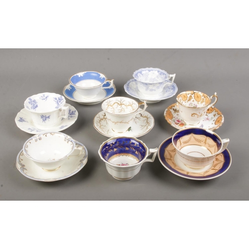 504 - A collection of 19th century porcelain teawares. Includes Rockingham examples with red and puce grif... 