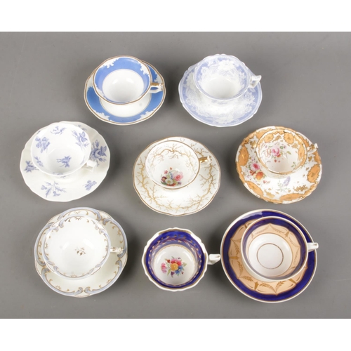 504 - A collection of 19th century porcelain teawares. Includes Rockingham examples with red and puce grif... 