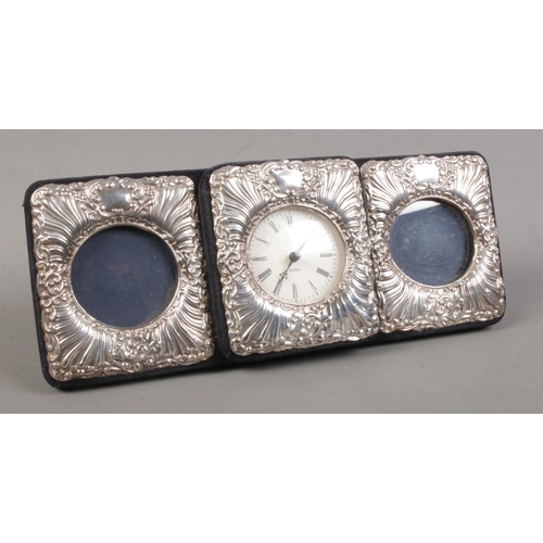 506 - A silver mounted three section easel display stand, with central quartz clock flanked by two circula... 