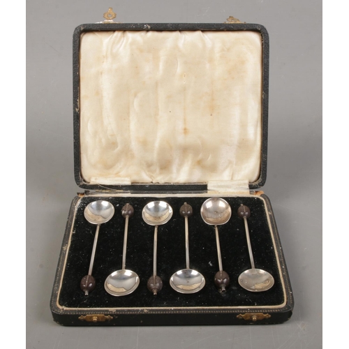 509 - A cased set of six silver demitasse spoons with coffee bean finials. Assayed for Birmingham, 1933 by... 