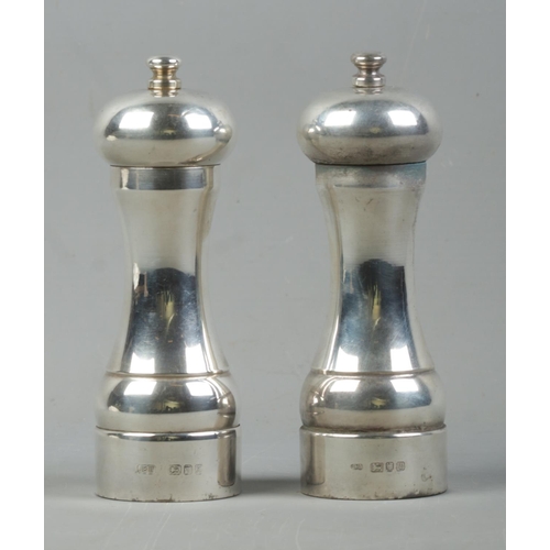 511 - A silver 'Peter Piper' salt and pepper mill set, both assayed for London, 1996 and 1997, by John Bul... 