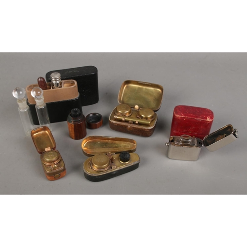 530 - A quantity of travelling inkwells including violin case, wooden turned and leather examples together... 