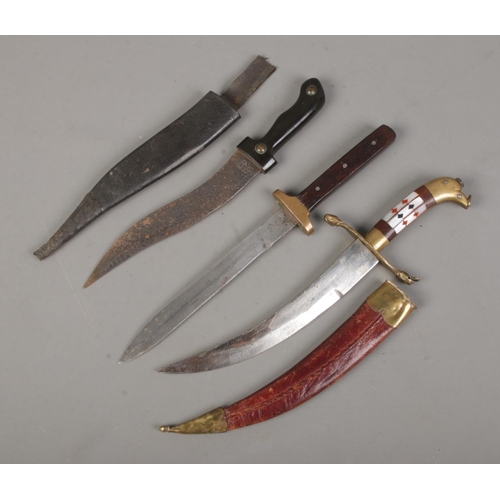 94 - Three daggers. Includes Eastern example with etched blade, Sheffield made example, etc. CANNOT POST ... 