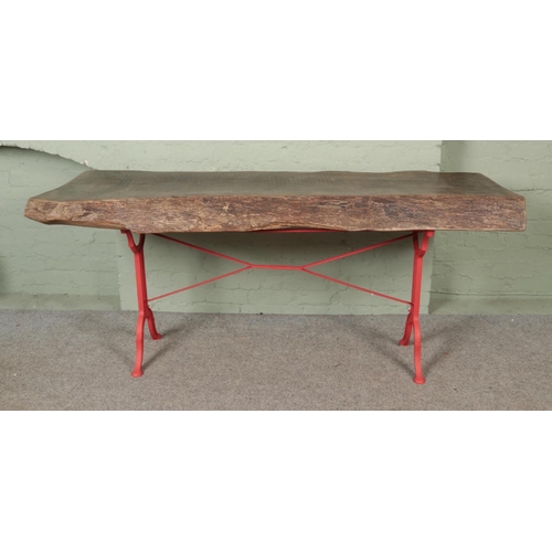 531 - A large chunky live/waney edge table with cast iron base having B G Tournus on either side of base. ... 