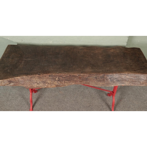 531 - A large chunky live/waney edge table with cast iron base having B G Tournus on either side of base. ... 