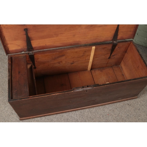 533 - An early 20th century stained pine blanket box of long proportions with twin handles and interior ca... 