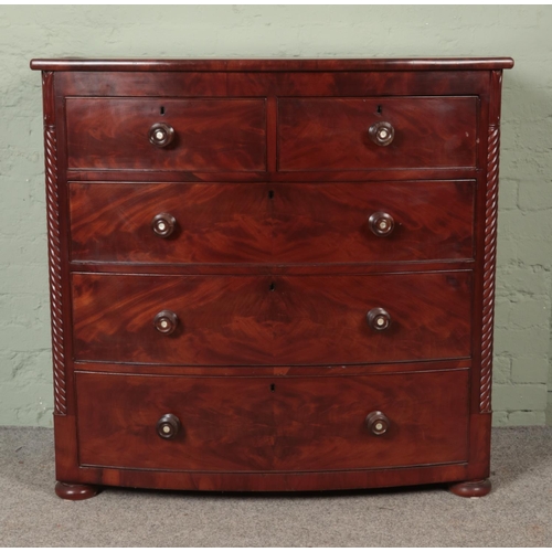 534 - A Victorian flame mahogany bow front chest of drawers with rope twist columns.

Hx110cm
Wx113cm
Dx54... 