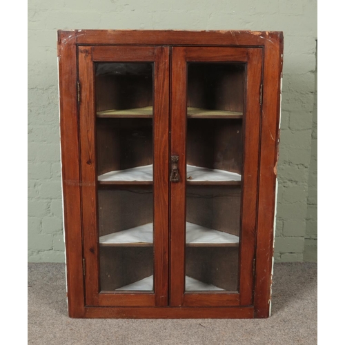 543 - An early 20th stained pine corner cabinet with glazed doors

Hx108cm
Wx79cm