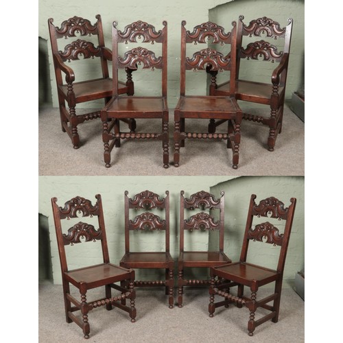 555 - A set of eight oak chairs. Having carved backs, jointed construction and bobbin turned stretchers. H... 