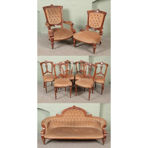 558 - An Edwardian inlaid mahogany and walnut parlour suite.