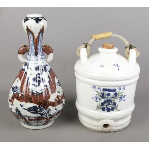 99 - A Chinese porcelain blue & white water vessel along with a Chinese baluster shaped vase with dragon ... 