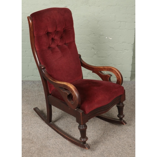 597 - A Victorian mahogany red upholstered rocking chair