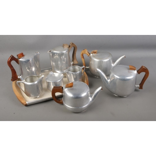 107 - A quantity of Picquot ware including tray, teapots, coffeepots, jugs and sugar bowl.