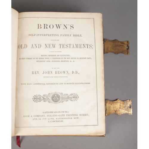 131 - A leather bound Brown's Self Interpreting Family Bible. With gilt decoration to cover, brass mounts ... 