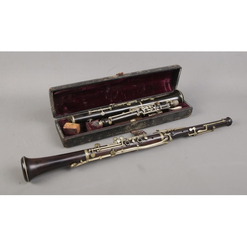 65 - Two two-piece oboes, produced by Boosey & Co. London and Henry Gunckle. Boosey & Co example with cas... 