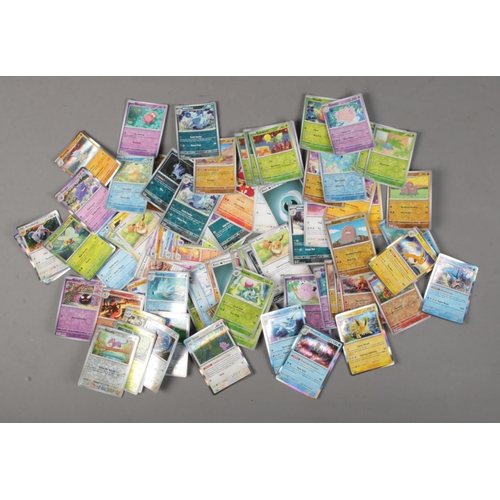 69 - A quantity of Pokemon cards including several holographic examples. Over 110 cards