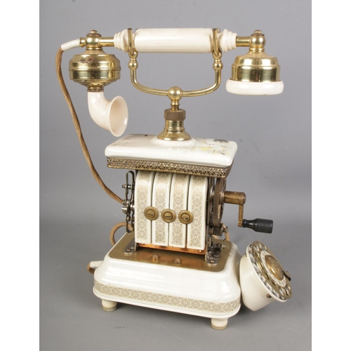 79 - An Expoga of Denmark crank telephone with white enamel and gilt decoration.