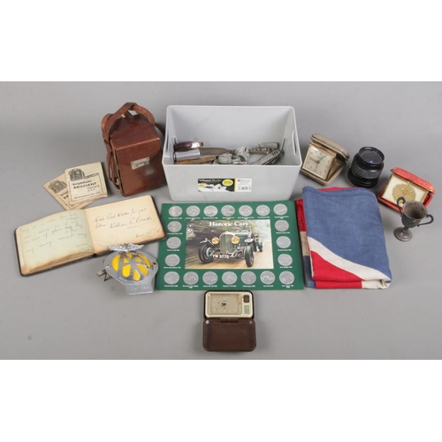 83 - A box of collectables. Includes Voigtlander Brilliant camera, autographs, AA car badge, medals, pock... 