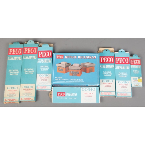 85 - Seven boxed Peco Streamline Flexible Trackage System along with a boxed Peco Office Building set.