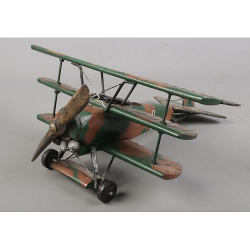 86 - A painted metal model of a tri-plane fighter. (34cm)