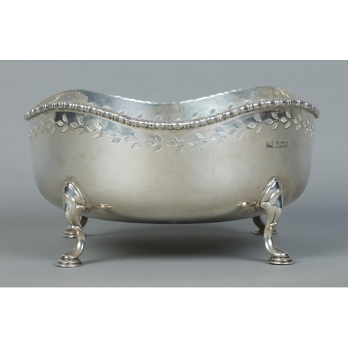 105 - A George V pierced silver bowl raised on four scrolled feet. Assayed Sheffield 1920 by Walker & Hall... 