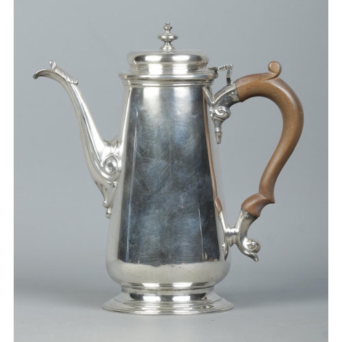 114 - A George VI silver hot water pot with urn shaped finial and wooden handle. Assayed London 1941 by Na... 