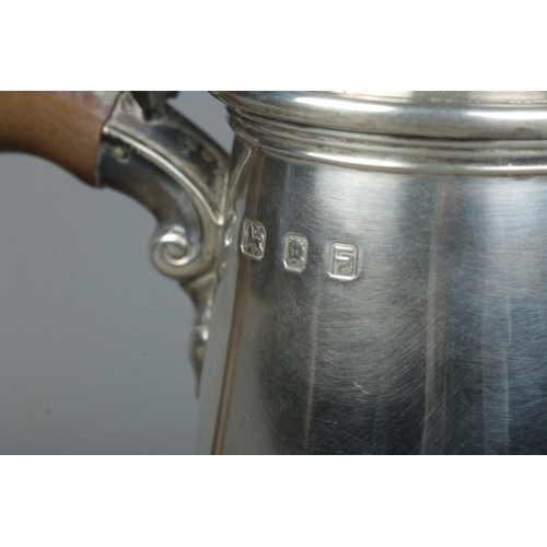 114 - A George VI silver hot water pot with urn shaped finial and wooden handle. Assayed London 1941 by Na... 