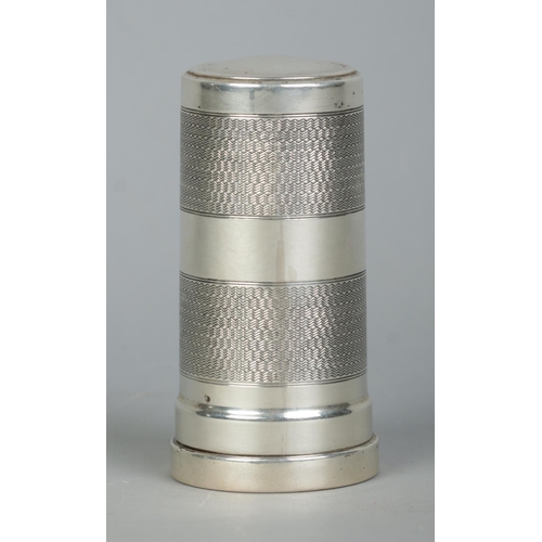 120 - A George V silver cylindrical shaving brush case with engine turned decoration. Housing a Kelson sha... 